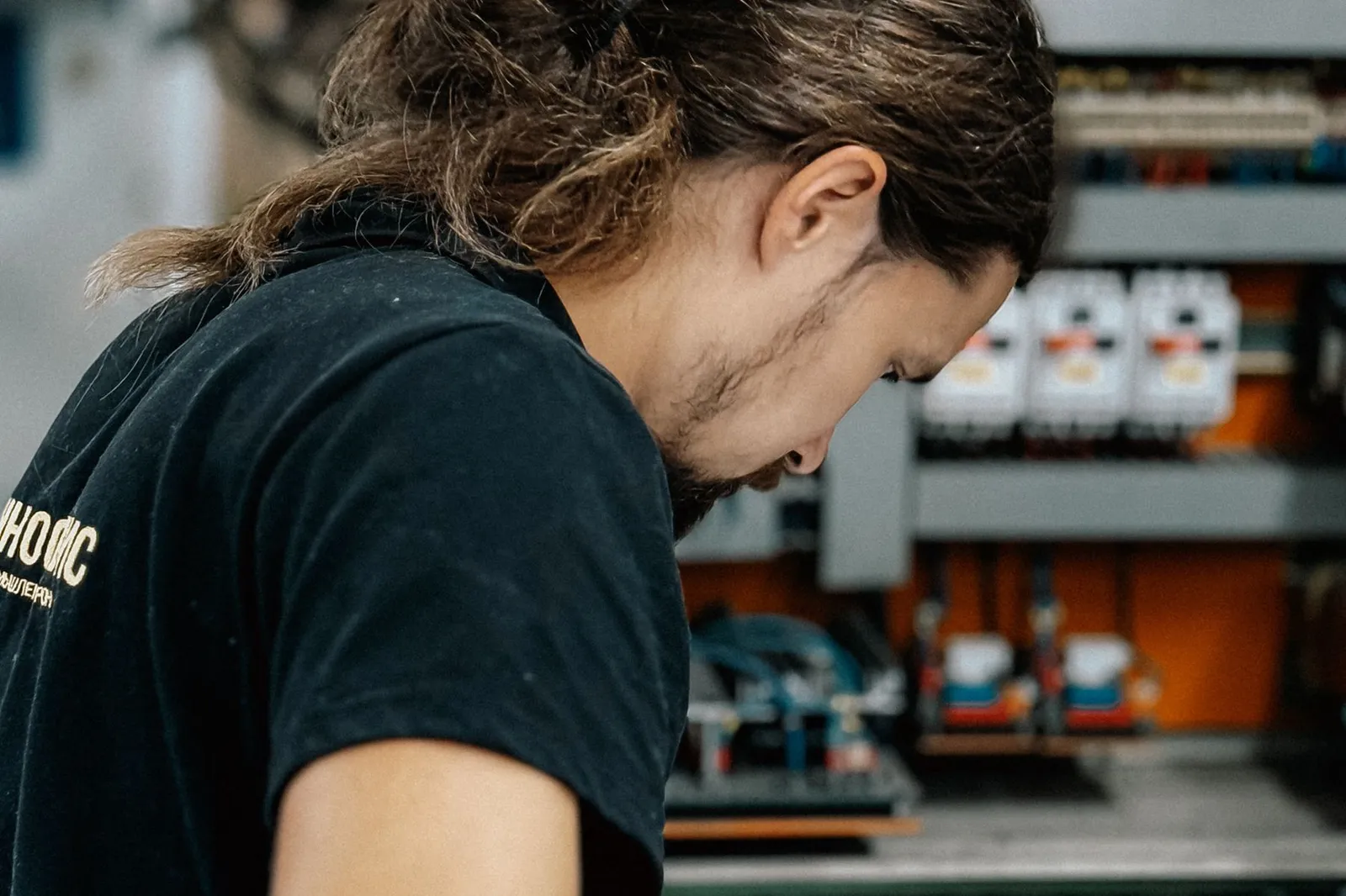 A technician works on an electrical panel